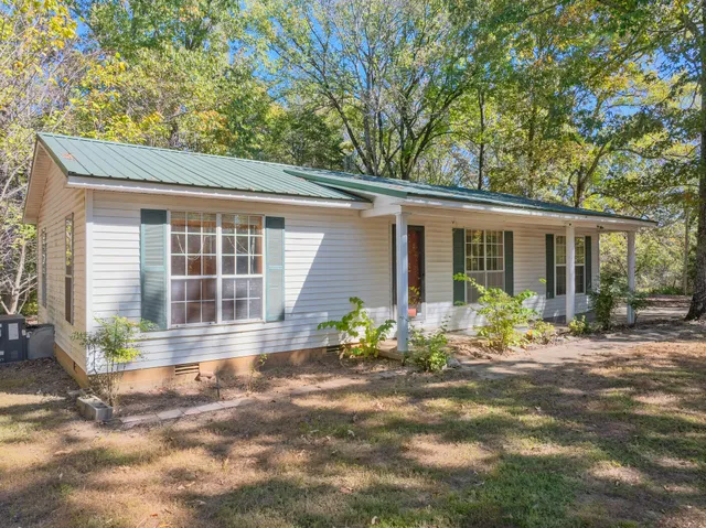a front view of a house with sitting area