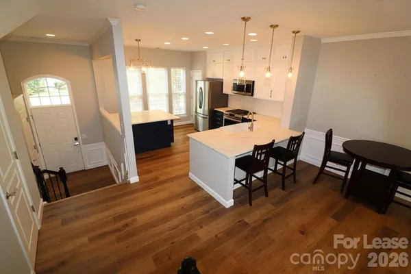 a large kitchen with a table and chairs