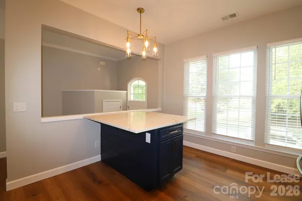 a kitchen with stainless steel appliances a sink cabinets and a wooden floor