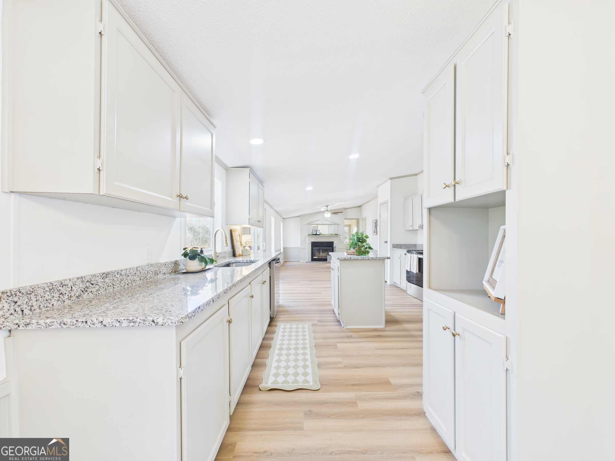 1669 Henderson Road Macon, GA 31217 - Photo 11 of 48 a kitchen with white cabinets and sink
