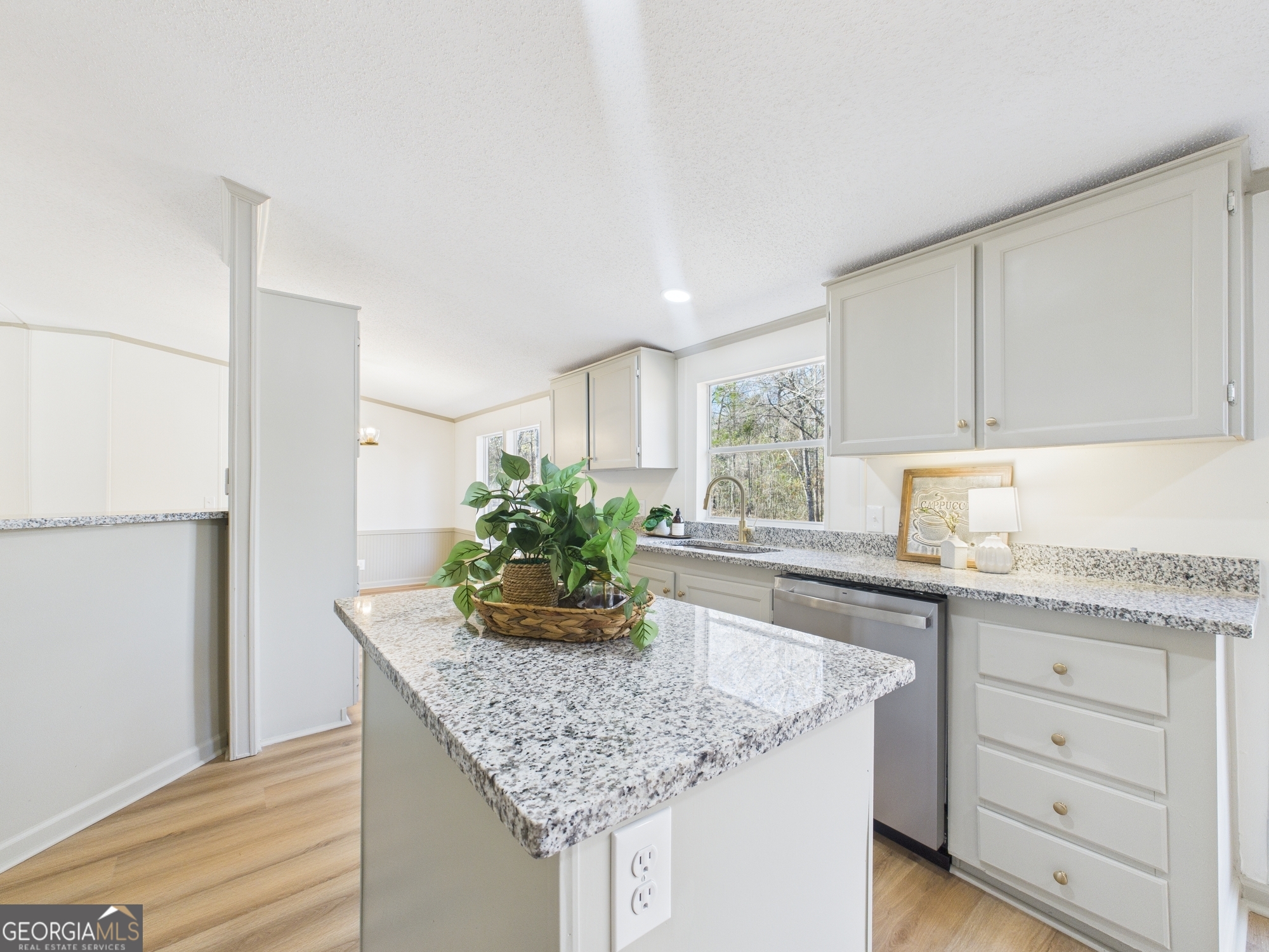 1669 Henderson Road Macon, GA 31217 - Photo 12 of 48 a kitchen with granite countertop a sink and cabinets