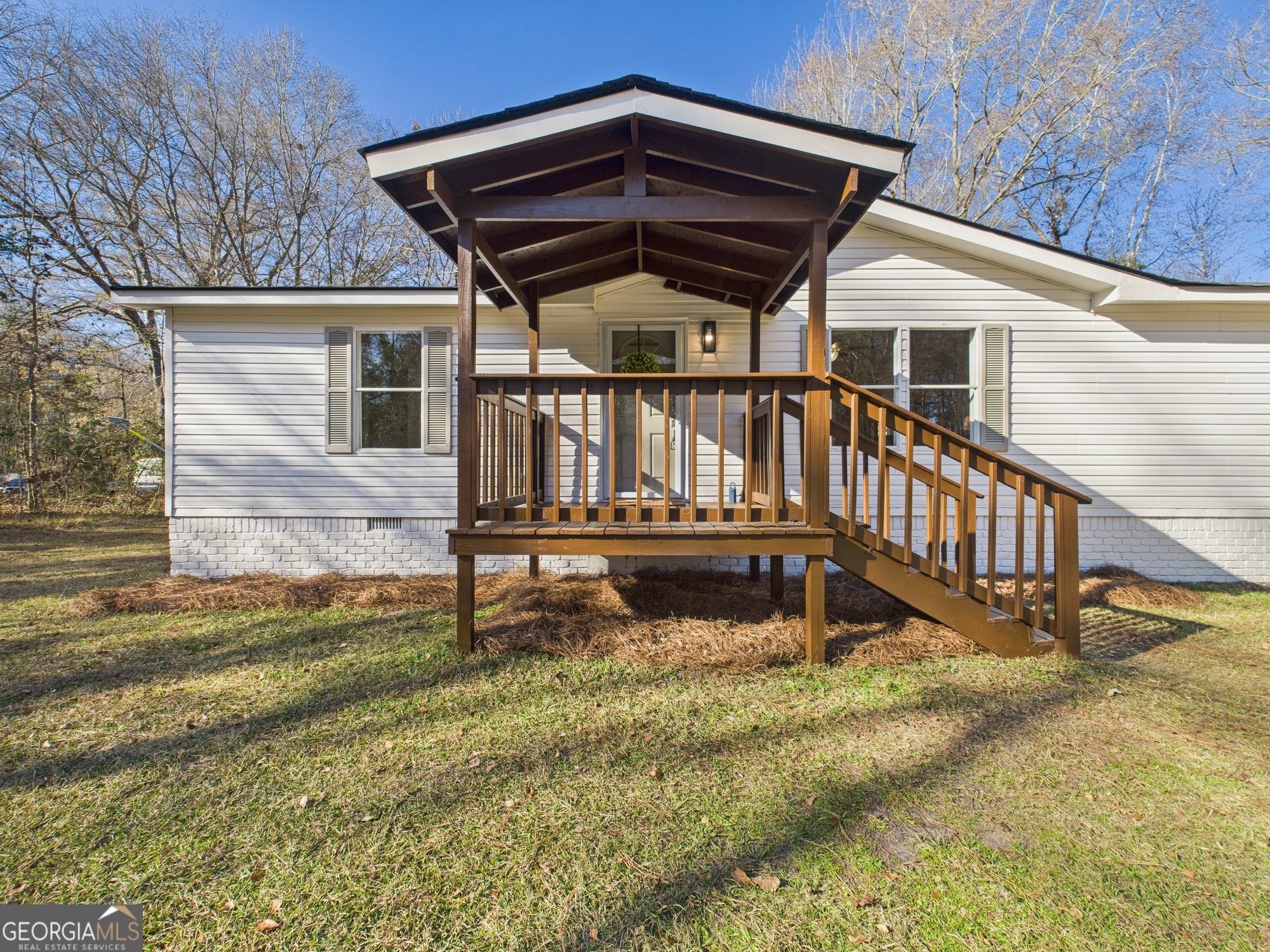 1669 Henderson Road Macon, GA 31217 - Photo 2 of 48 a view of a house with wooden wall roof and a small yard