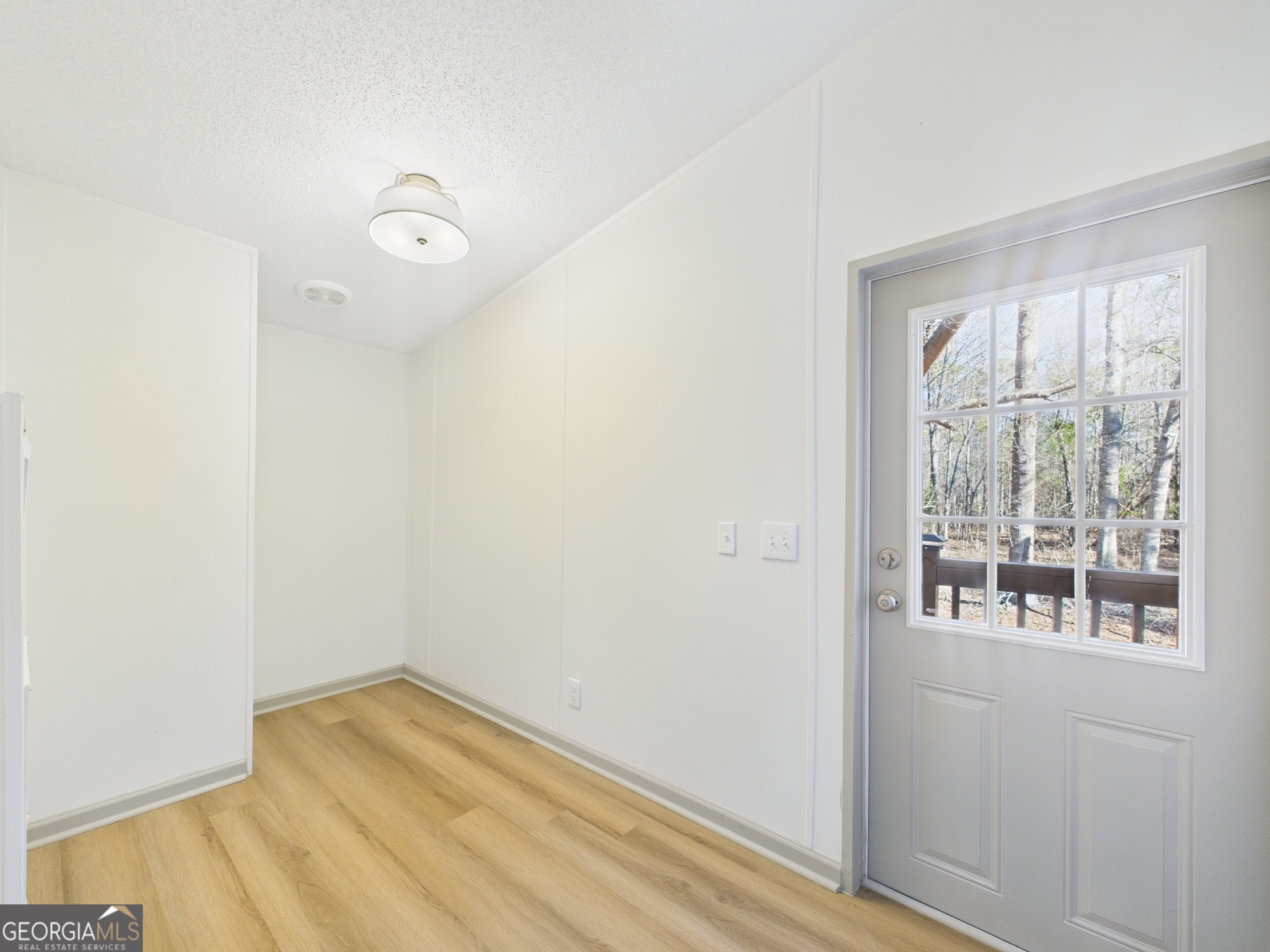 1669 Henderson Road Macon, GA 31217 - Photo 22 of 48 a view of empty room with wooden floor and fan