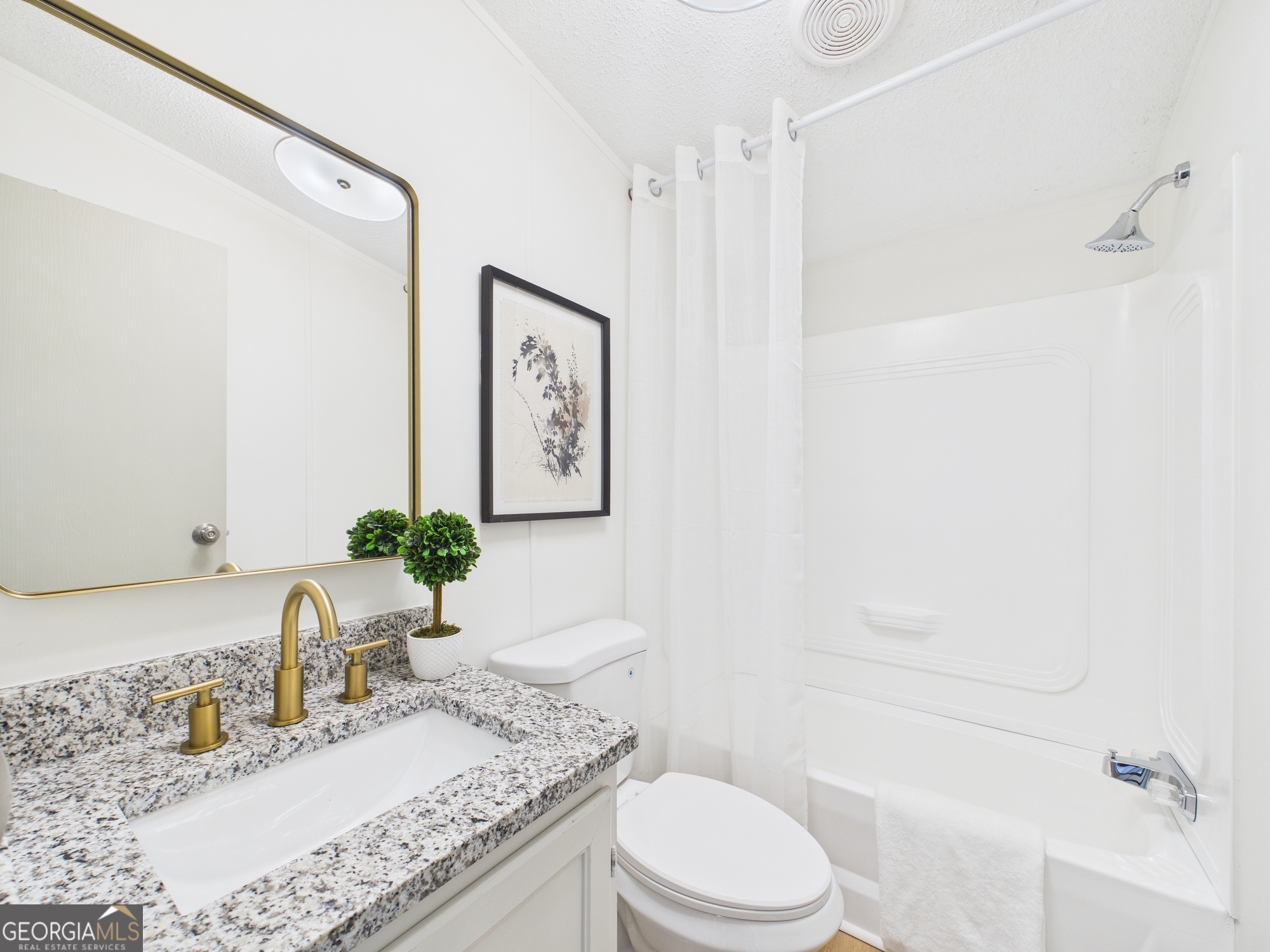1669 Henderson Road Macon, GA 31217 - Photo 27 of 48 a bathroom with a granite countertop sink toilet and shower