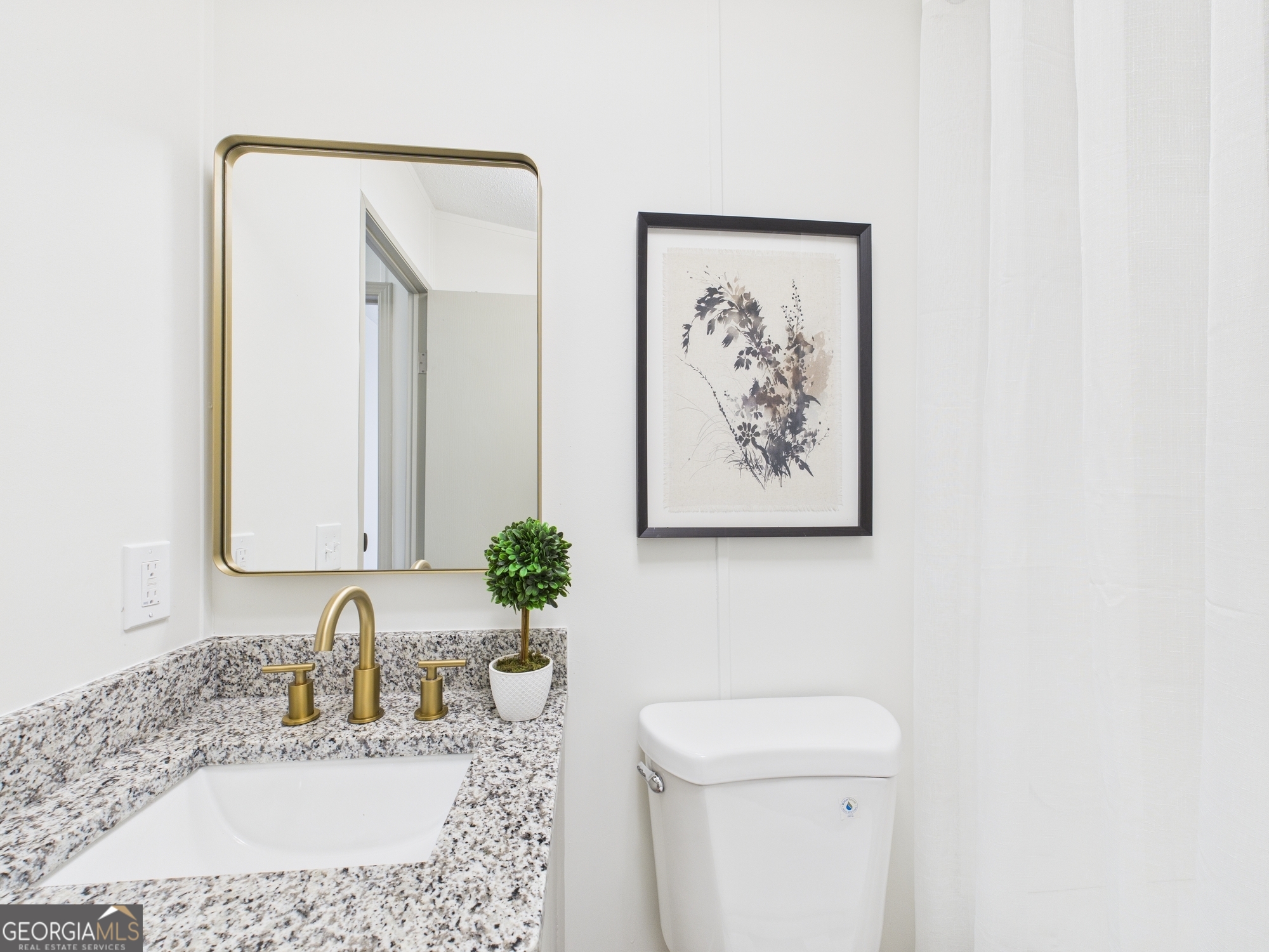 1669 Henderson Road Macon, GA 31217 - Photo 28 of 48 a bathroom with a granite countertop sink a toilet and a mirror