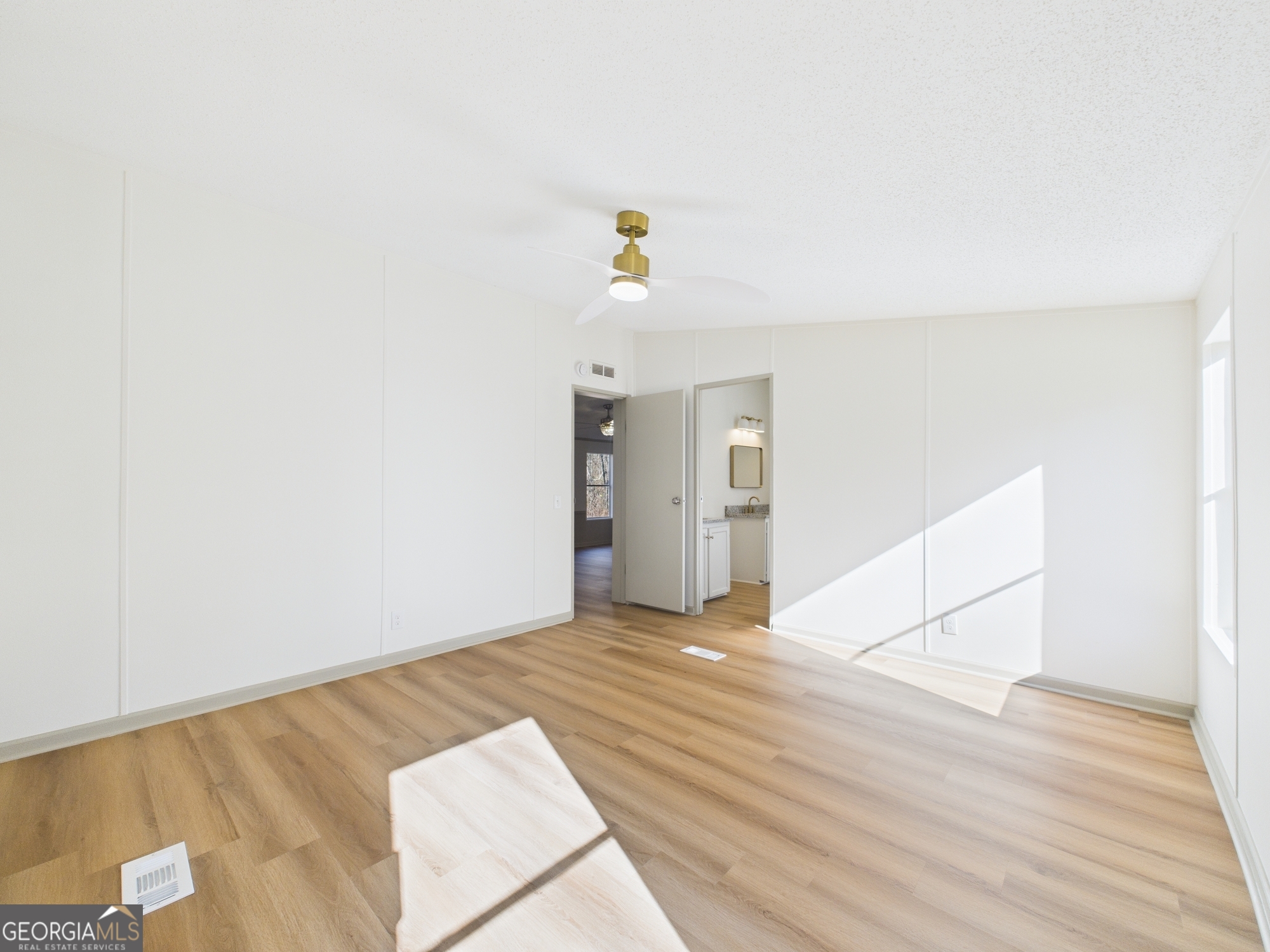 1669 Henderson Road Macon, GA 31217 - Photo 32 of 48 a view of an empty room with wooden floor and a window
