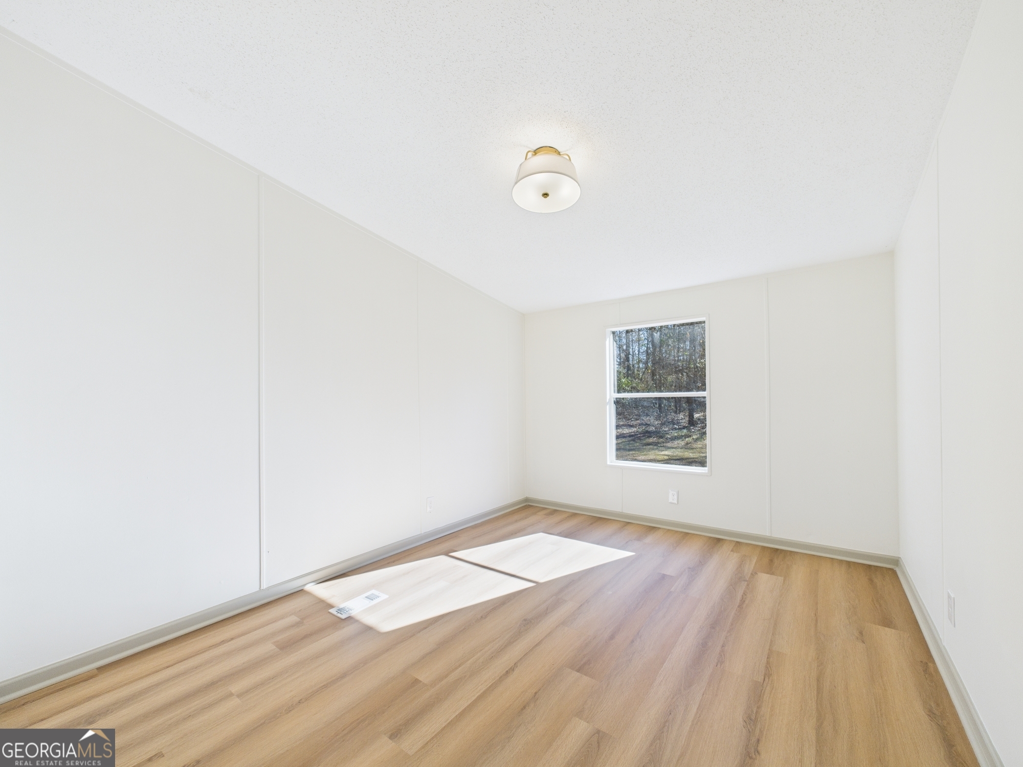 1669 Henderson Road Macon, GA 31217 - Photo 38 of 48 an empty room with wooden floor and windows