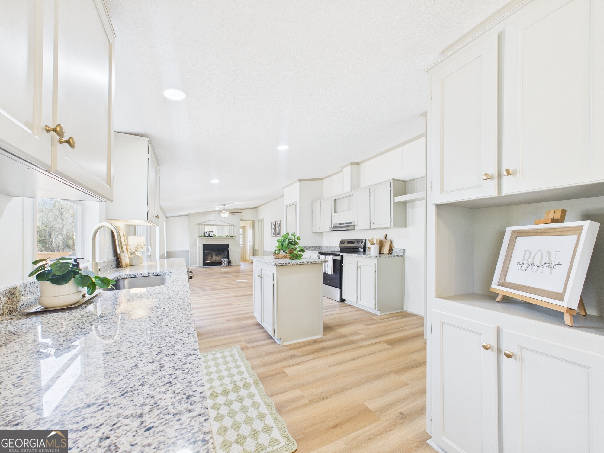 1669 Henderson Road Macon, GA 31217 - Photo 10 of 48 a large white kitchen with cabinets