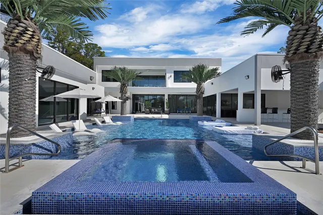 a view of house with swimming pool outdoor seating