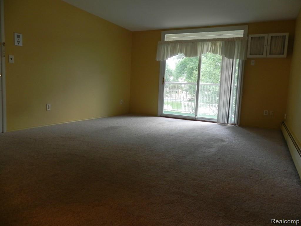 4905 Crooks Road, Unit 66 Royal Oak, MI 48073 - Photo 6 of 19 Large living room with door wall to good sized balcony