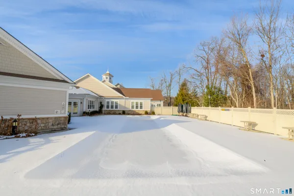 a view of a house with a yard covered in snow