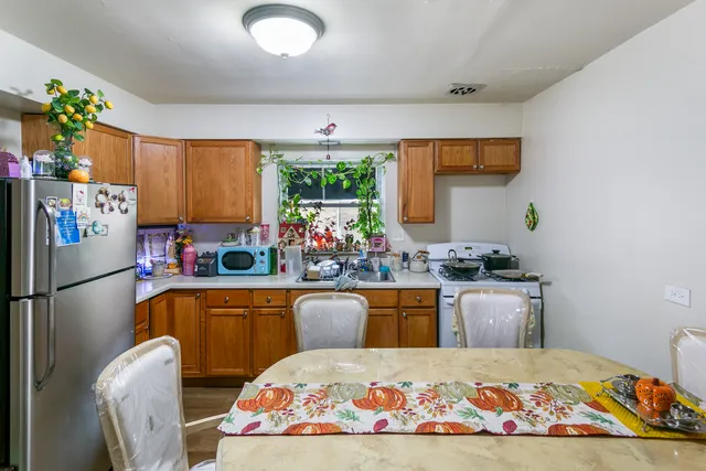 a kitchen with a refrigerator and a sink