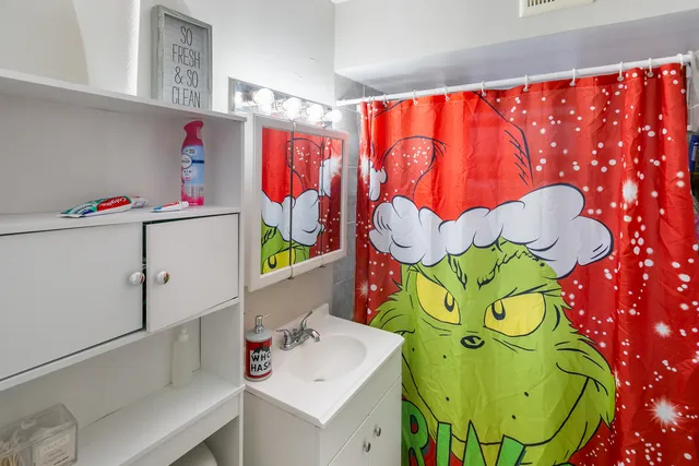 a bathroom with a sink mirror and vanity