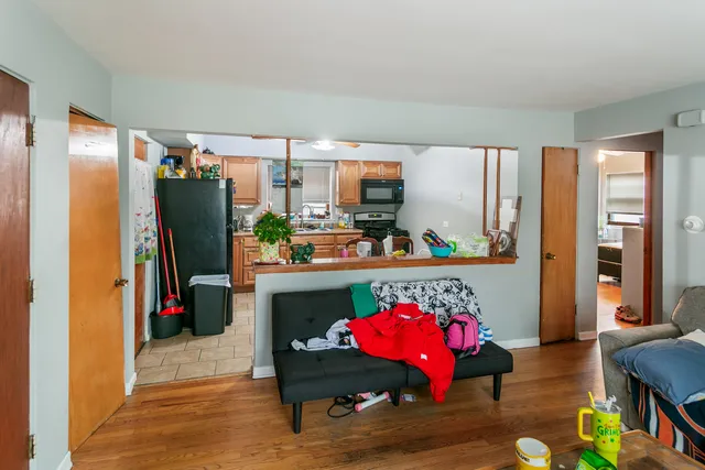 a living room with furniture and wooden floor