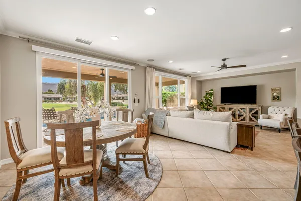 a view of a dining room with furniture wooden floor and a flat screen tv