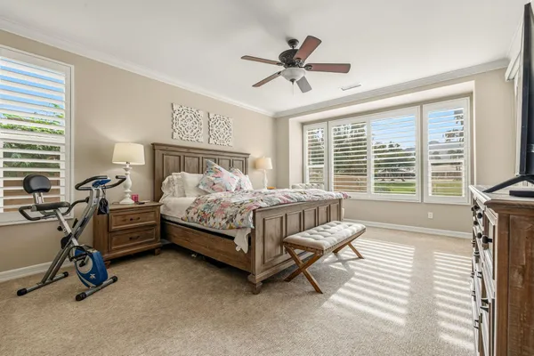 a bedroom with furniture and a large window
