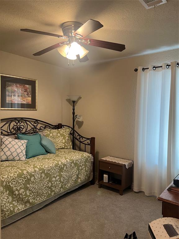 312 McAfee Street Mabank, TX 75147 - Photo 12 of 40 Carpeted bedroom with a textured ceiling and ceiling fan