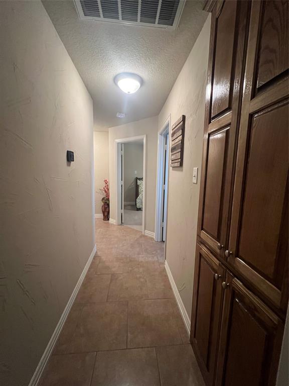 312 McAfee Street Mabank, TX 75147 - Photo 13 of 40 a view of hallway with stainless steel appliances wooden floor