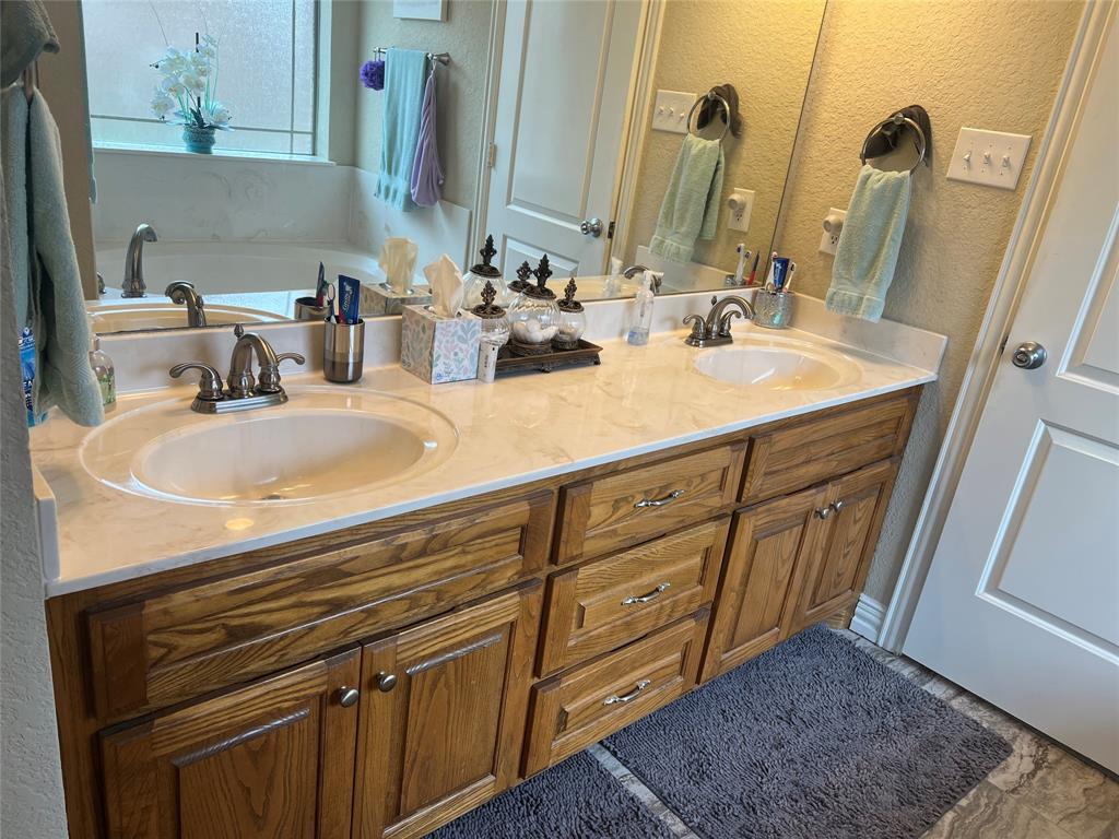 312 McAfee Street Mabank, TX 75147 - Photo 19 of 40 a bathroom with a sink and a mirror