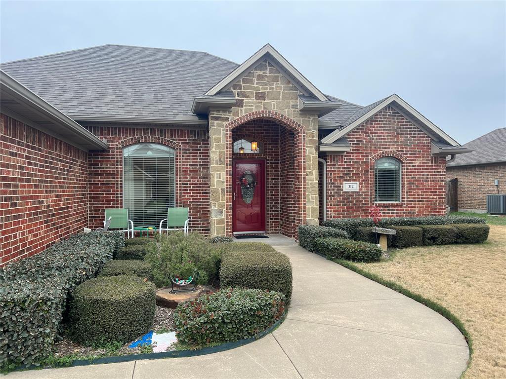 312 McAfee Street Mabank, TX 75147 - Photo 2 of 40 a front view of a house with garden