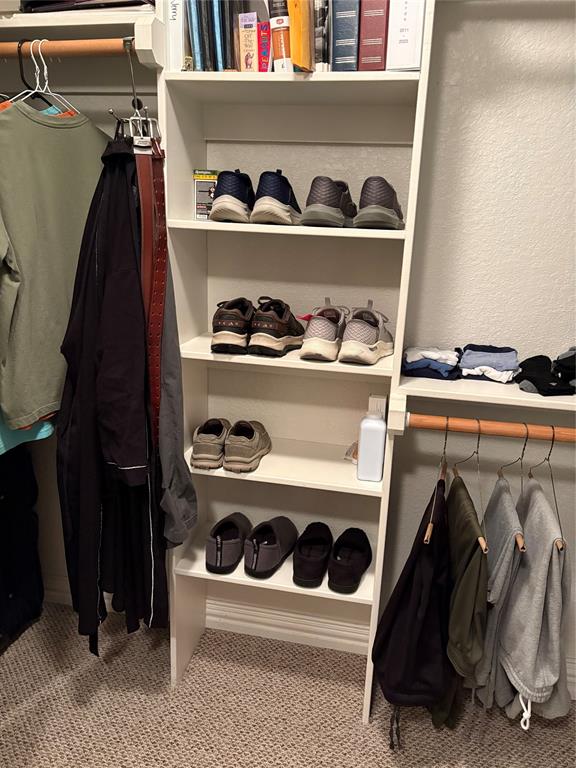 312 McAfee Street Mabank, TX 75147 - Photo 23 of 40 a view of walk in closet with clothes and shoes
