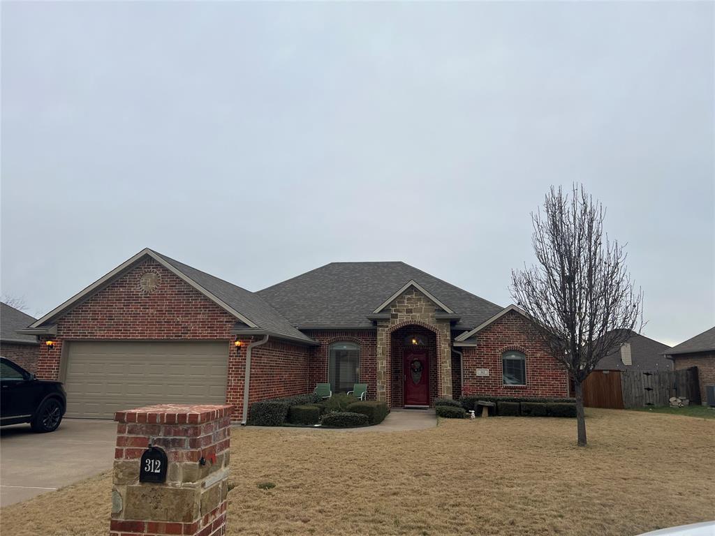 312 McAfee Street Mabank, TX 75147 - Photo 3 of 40 a front view of a house with a yard