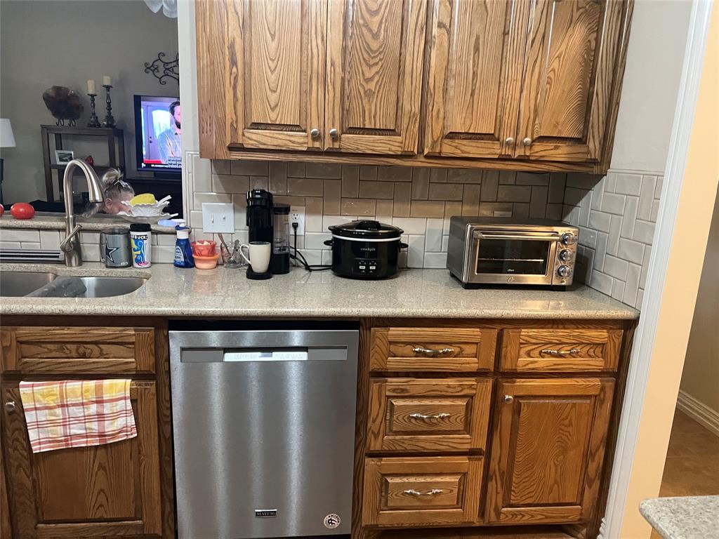 312 McAfee Street Mabank, TX 75147 - Photo 31 of 40 a kitchen with stainless steel appliances granite countertop a refrigerator and a stove