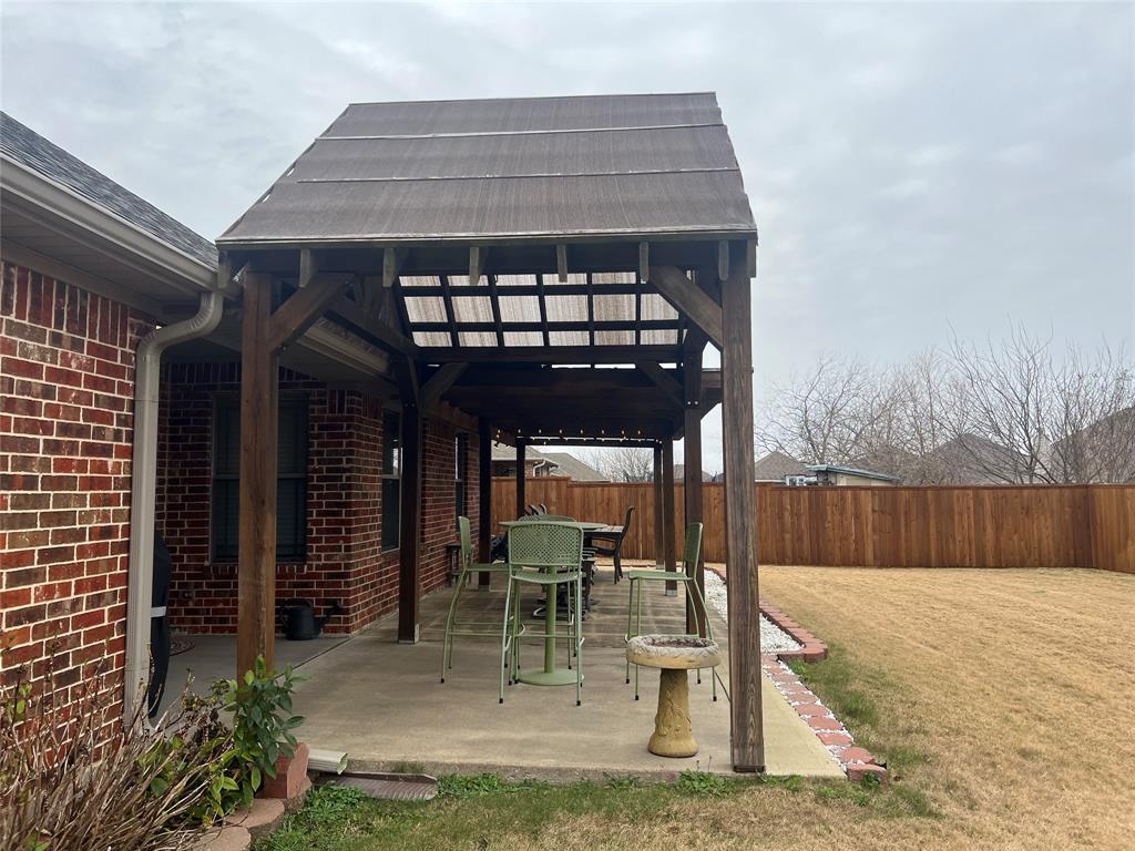 312 McAfee Street Mabank, TX 75147 - Photo 33 of 40 a view of a chairs and table in the patio