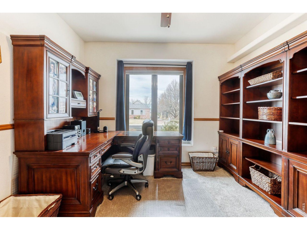 640 Valley View Road Loveland, CO 80537 - Photo 18 of 40 a living room with furniture cabinets and a flat screen tv