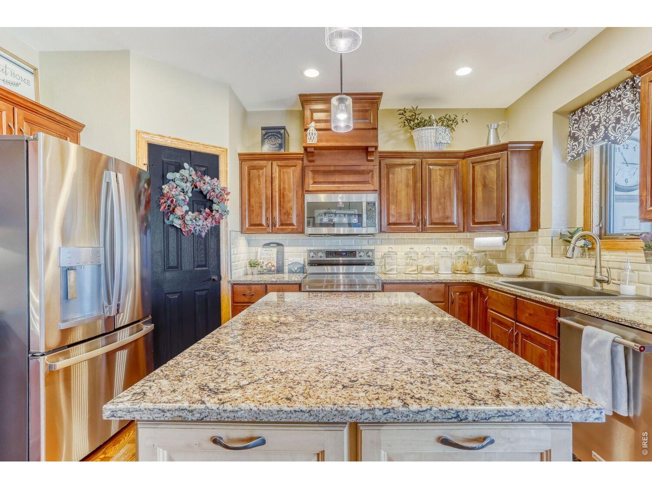 640 Valley View Road Loveland, CO 80537 - Photo 8 of 40 a kitchen with stainless steel appliances granite countertop wooden cabinets and a refrigerator