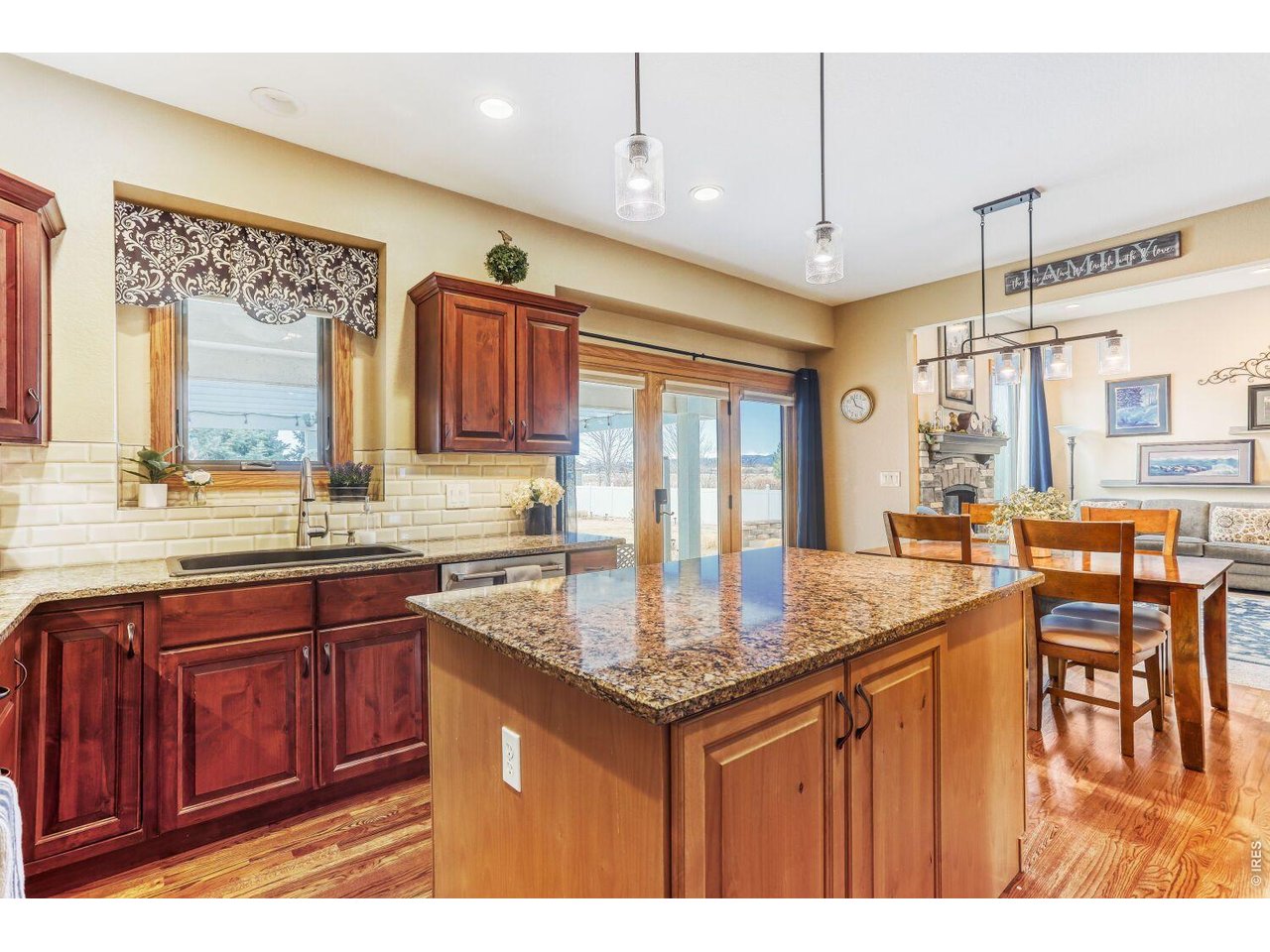 640 Valley View Road Loveland, CO 80537 - Photo 9 of 40 a kitchen with granite countertop a sink cabinets and wooden floor