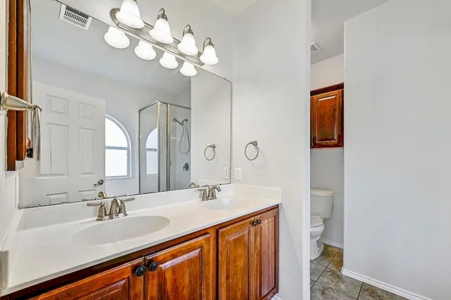 a bathroom with a sink a toilet and mirror