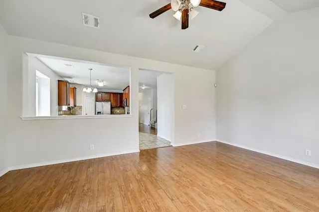 a large kitchen with stainless steel appliances granite countertop a stove top oven a sink dishwasher a dining table and chairs