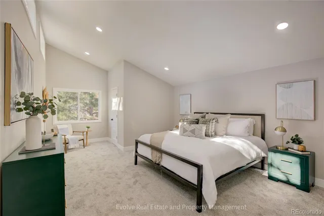 a spacious bedroom with a bed and a large mirror