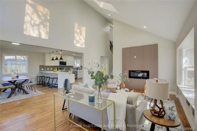 a living room with fireplace furniture and a wooden floor