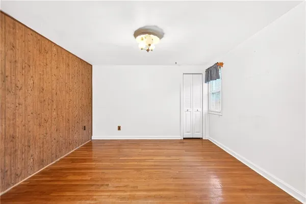 a view of a room with wooden floor and potted plants