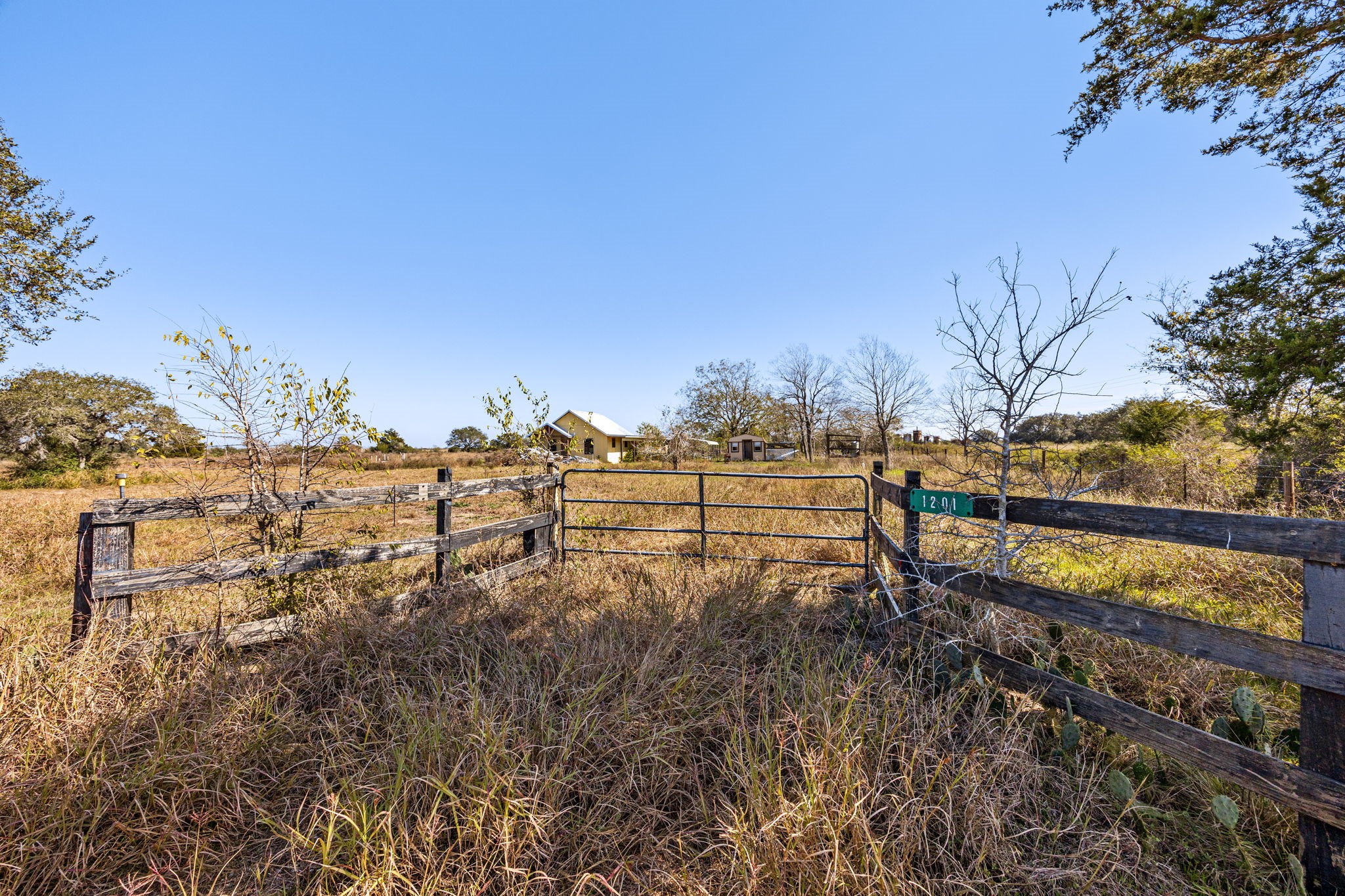 1187-1201 Ramsey Road Alleyton, TX 78935 - Photo 12 of 32 a view of a yard with wooden fence