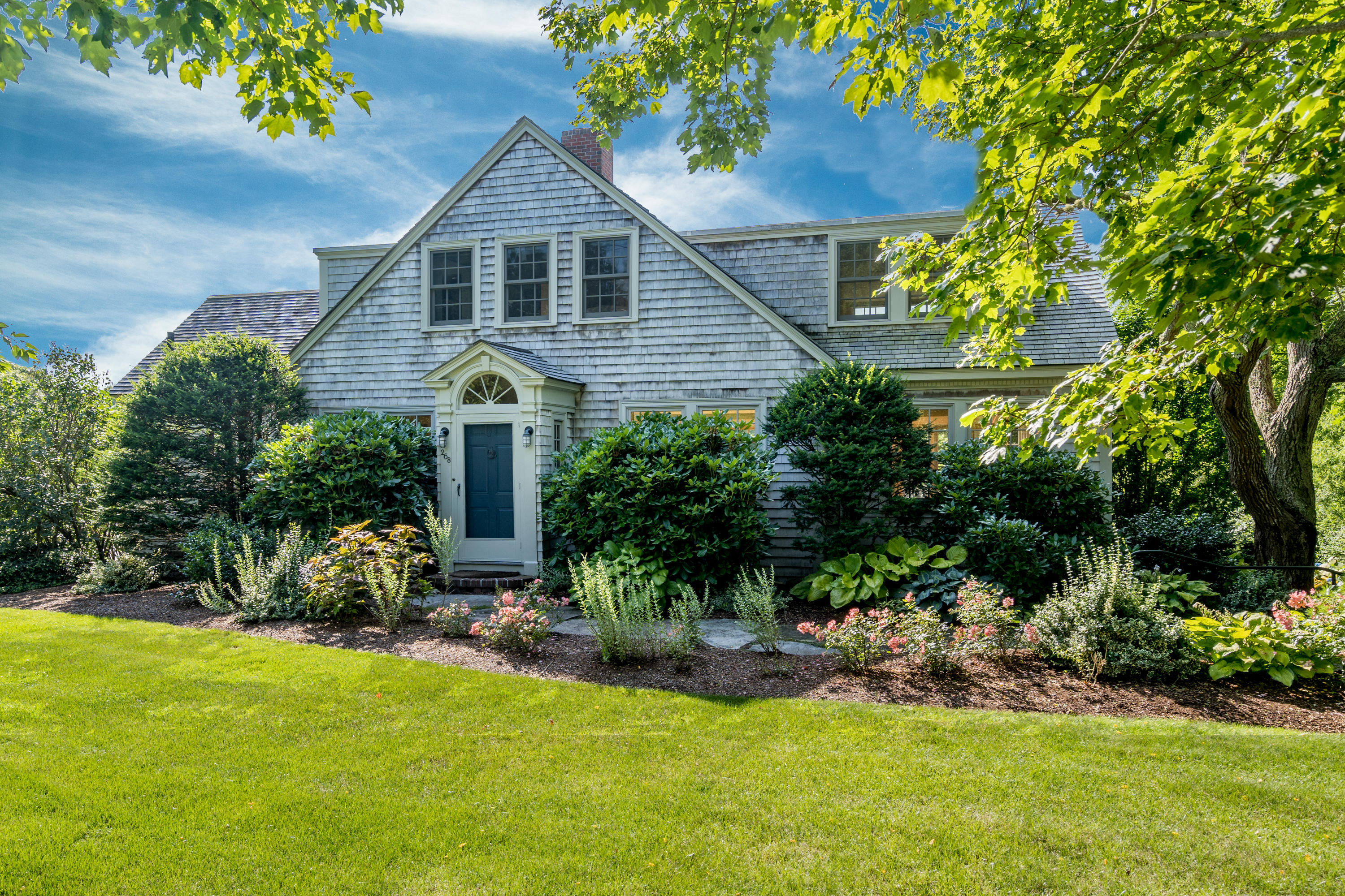a front view of house with yard and green space