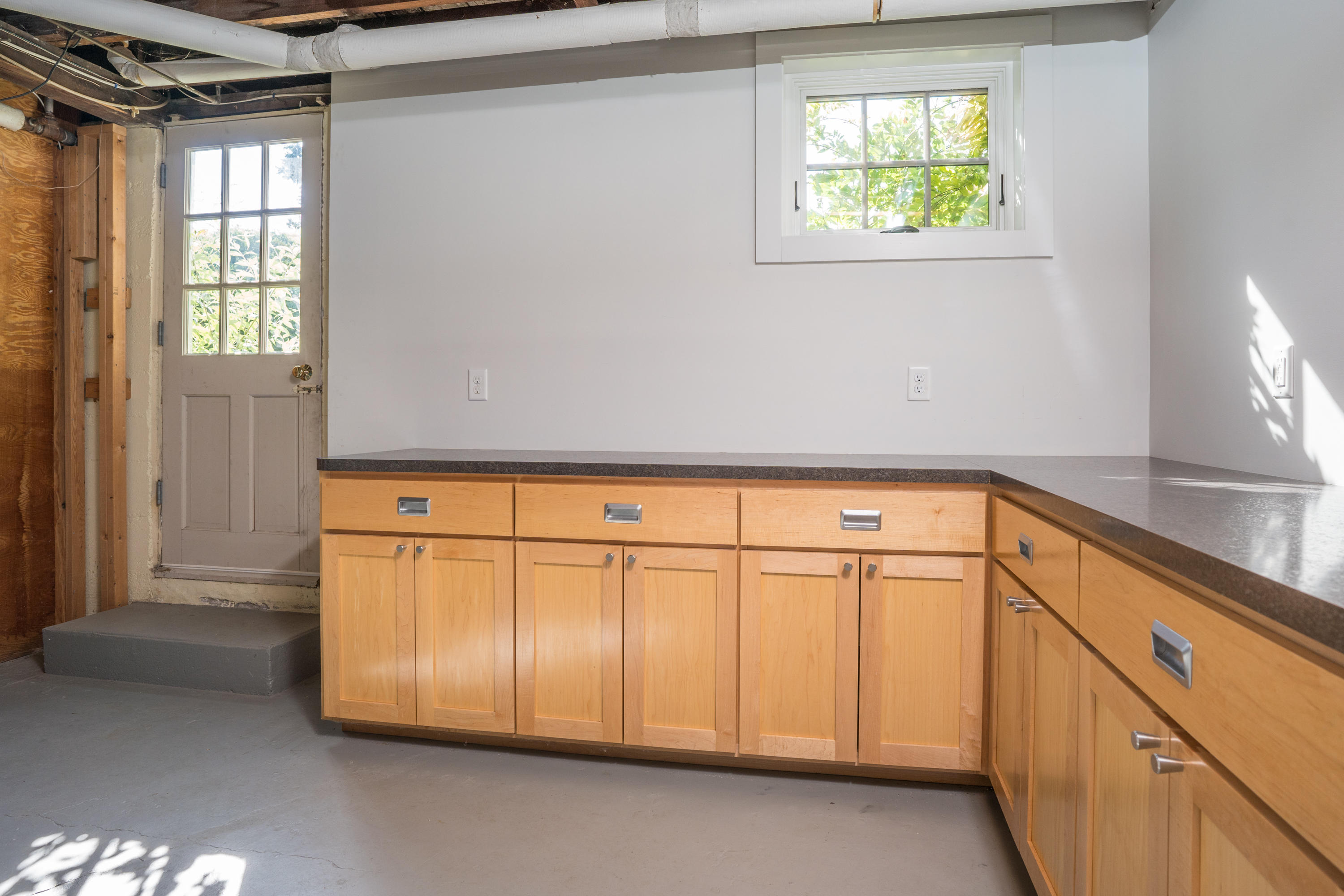 268 Elm Road Falmouth, MA 02540 - Photo 19 of 29 a view of a kitchen with wooden floor and a window