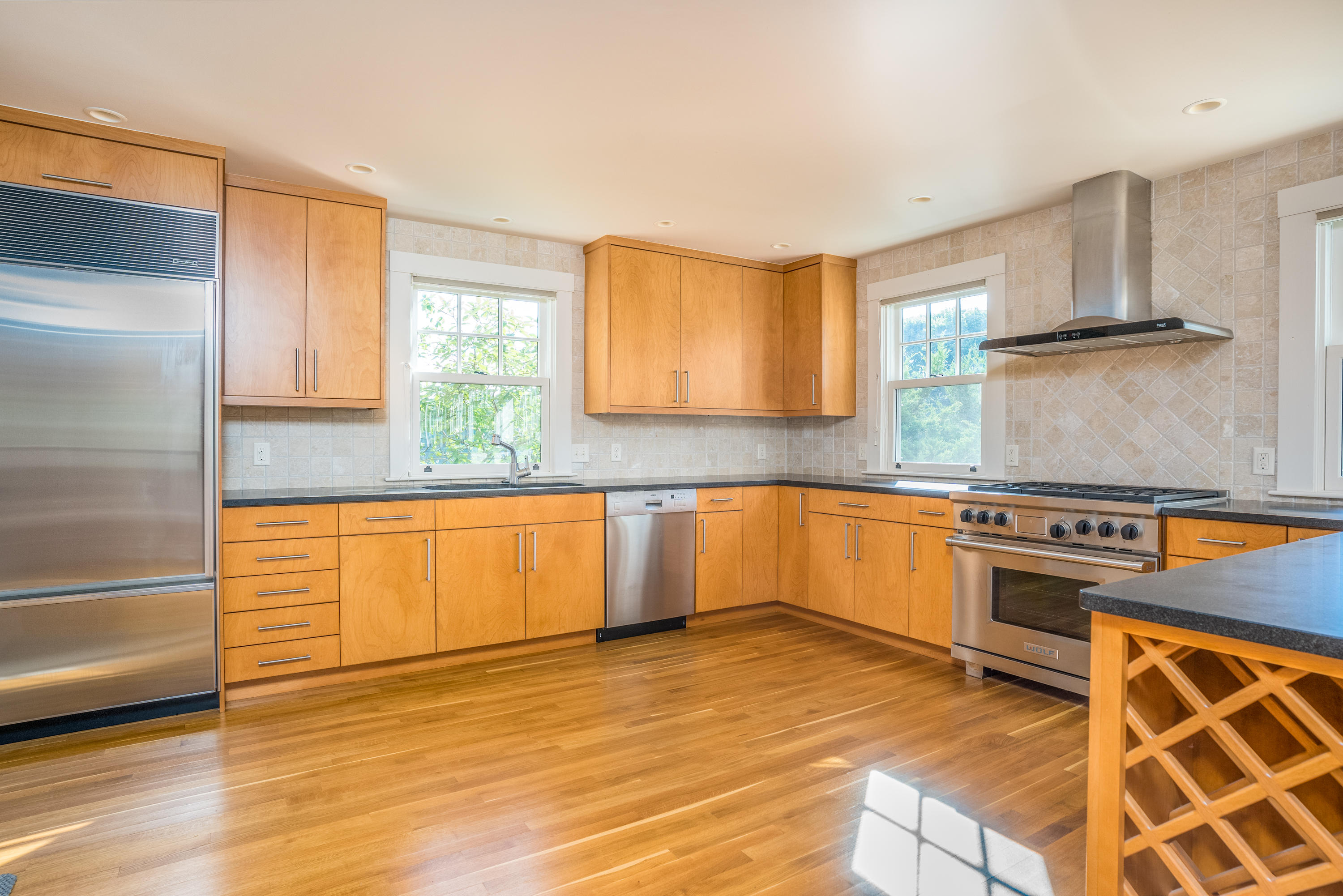 268 Elm Road Falmouth, MA 02540 - Photo 9 of 29 a kitchen with stainless steel appliances granite countertop a stove a sink and a refrigerator