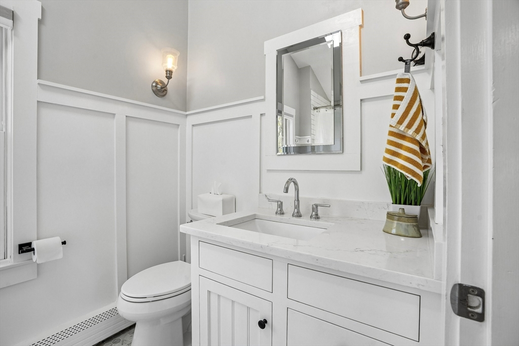 12 Hawley Road Scituate, MA 02066 - Photo 13 of 24 a bathroom with a sink a toilet and mirror
