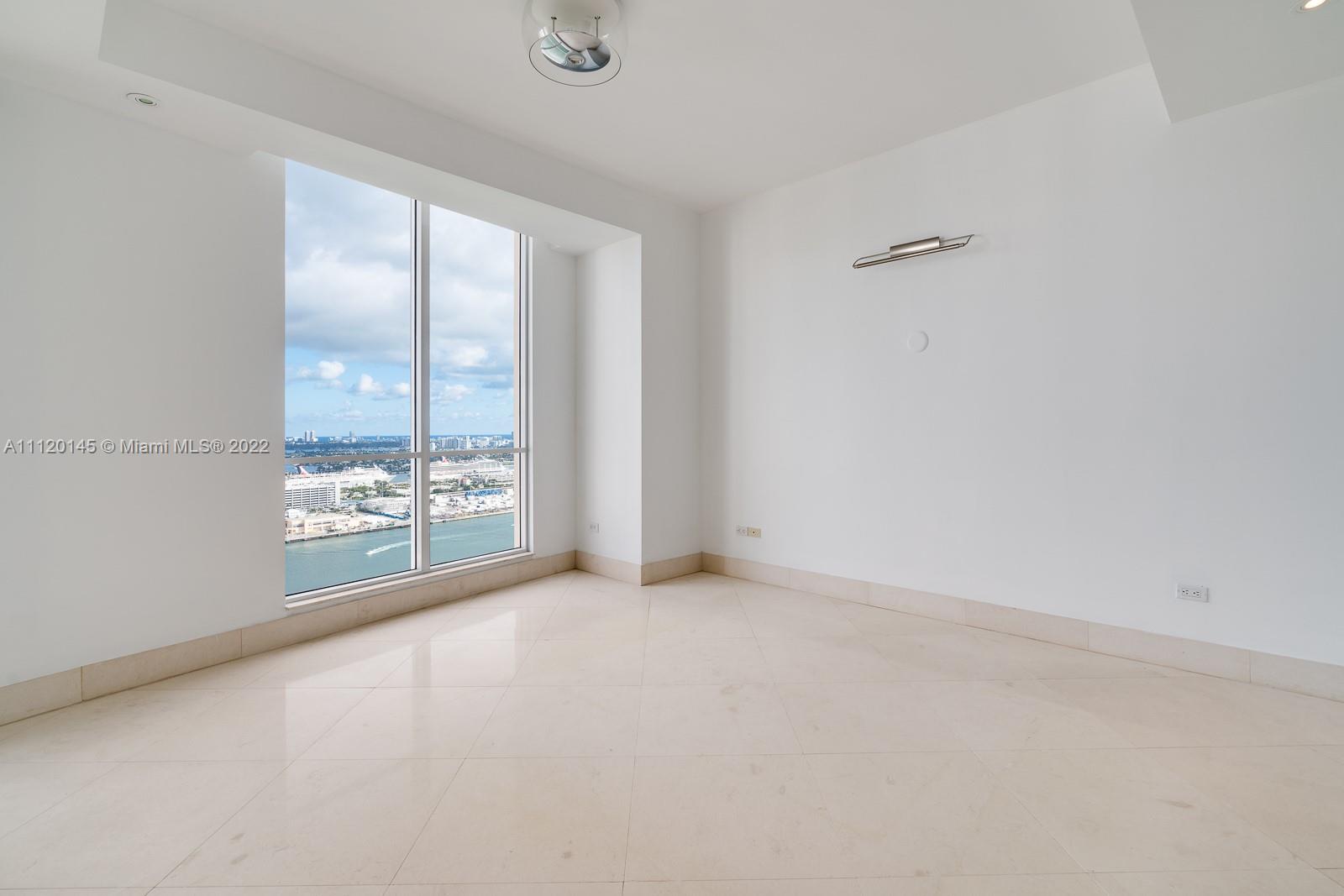 848 Brickell Key Drive, Unit 4002 Miami, FL 33131 - Photo 12 of 19 an empty room with windows