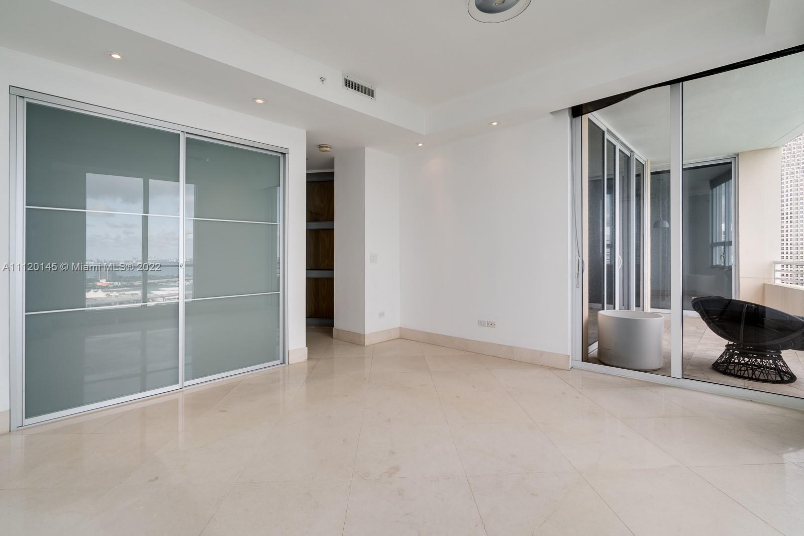 848 Brickell Key Drive, Unit 4002 Miami, FL 33131 - Photo 13 of 19 an empty room with windows and closet