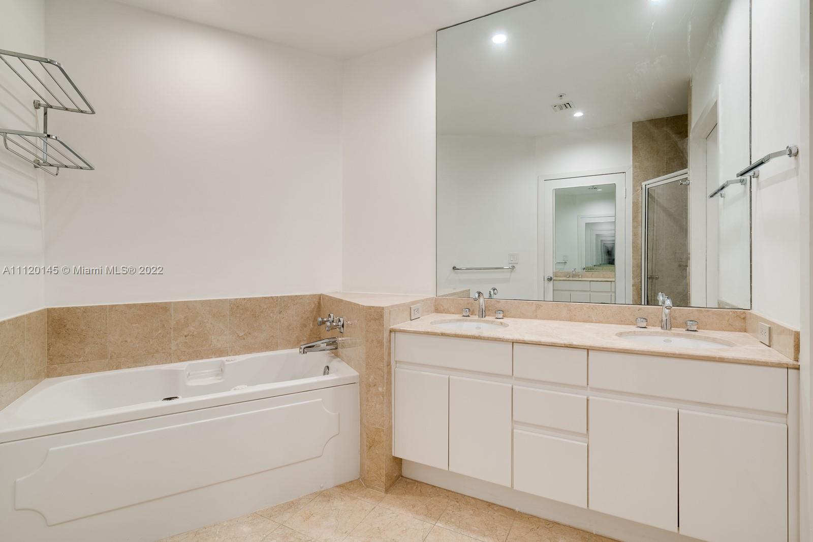 848 Brickell Key Drive, Unit 4002 Miami, FL 33131 - Photo 14 of 19 a bathroom with a bathtub and a sink