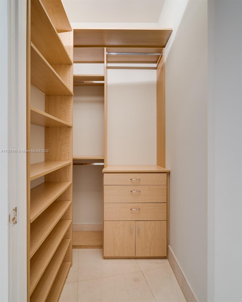 848 Brickell Key Drive, Unit 4002 Miami, FL 33131 - Photo 16 of 19 a view of walk in closet with empty racks