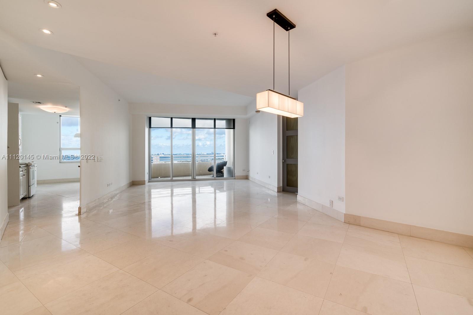 848 Brickell Key Drive, Unit 4002 Miami, FL 33131 - Photo 3 of 19 a view of a big room with windows and chandelier