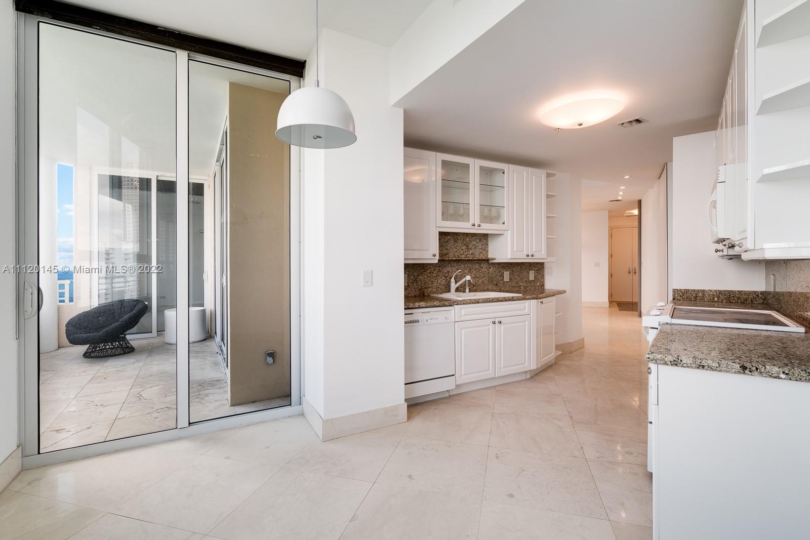 848 Brickell Key Drive, Unit 4002 Miami, FL 33131 - Photo 8 of 19 a kitchen with a refrigerator and a stove