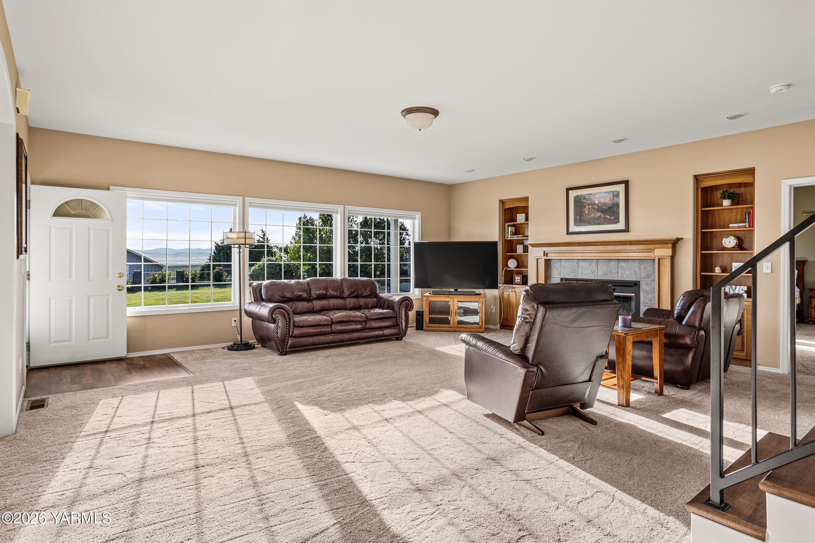 5060 Lombard Loop Road Zillah, WA 98953 - Photo 14 of 65 a living room with furniture a flat screen tv and a fireplace