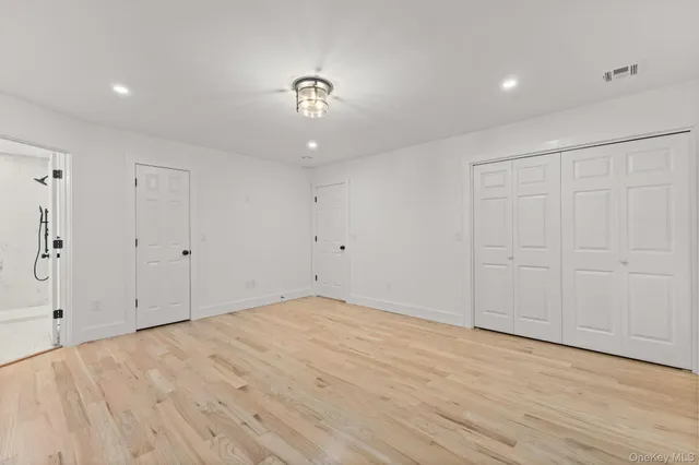 a bathroom with a toilet a sink a mirror and vanity