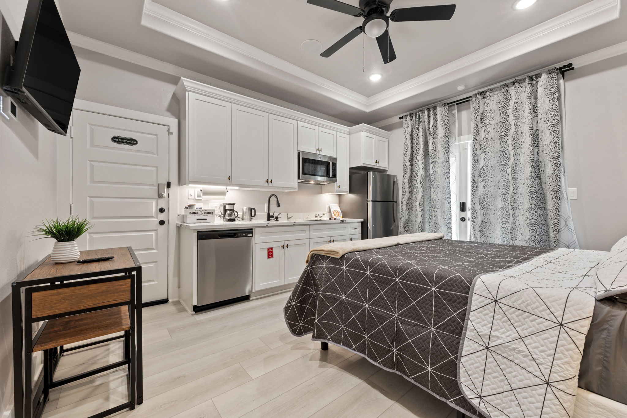 a bedroom with a bed and a flat screen tv